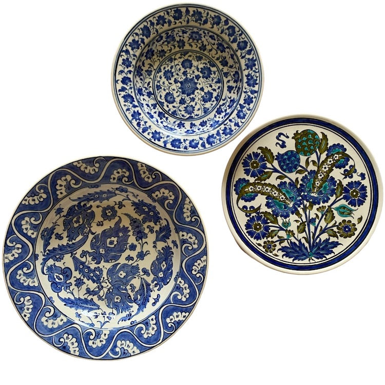 The Voyage Dubai - A set of beautiful hand-painted Iznik ceramic plates from Turkey.  The trio of plates, featuring intricate floral designs in a classic blue and white palette, make a stunning addition to any home.