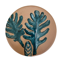 The Voyage Dubai - The Prickly Pear small saucer plate is a beautiful, hand painted piece, inspired by the Mediterranean landscape. This unique piece is an eye-catching addition to any kitchen, dining room, or living space. Use as a saucer or a lovely display piece to create an interesting vignette.