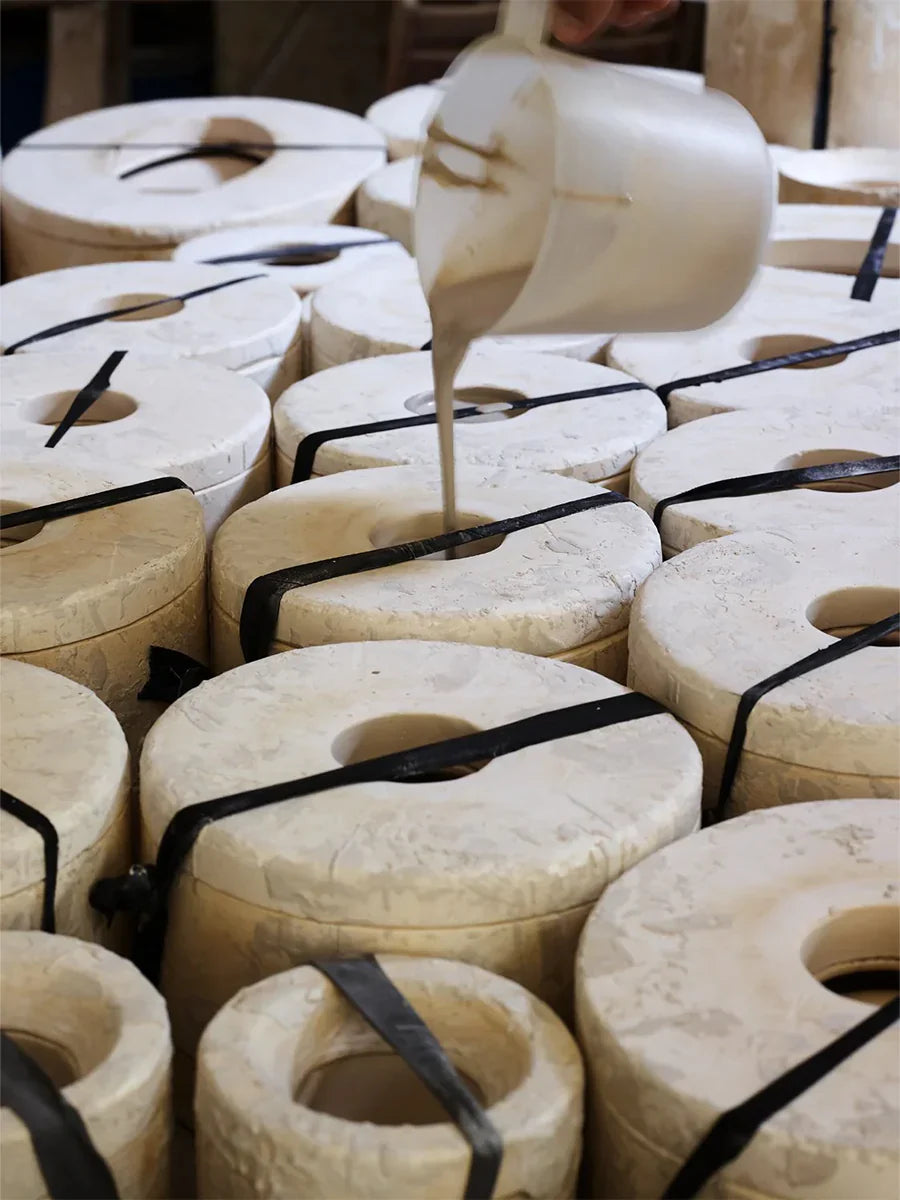 Liquid clay being poured into handmade plaster moulds at Villa Bologna Pottery, Attard, Malta