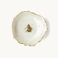 Handmade in a small studio in Notting Hill by Heidi Bishop, this stunning porcelain 'jagged' bowl features a delicate hand painted bee and is finished with gold edging.