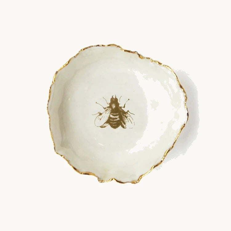 Handmade in a small studio in Notting Hill by Heidi Bishop, this stunning porcelain 'jagged' bowl features a delicate hand painted bee and is finished with gold edging.