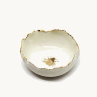Handmade in a small studio in Notting Hill by Heidi Bishop, this stunning porcelain 'jagged' bowl features a delicate hand painted bee and is finished with gold edging.