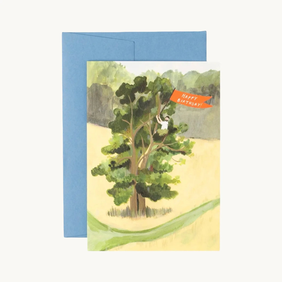 Birthday card of a man in a tall green tree waving an orange Happy Birthday flag, with a blue envelope