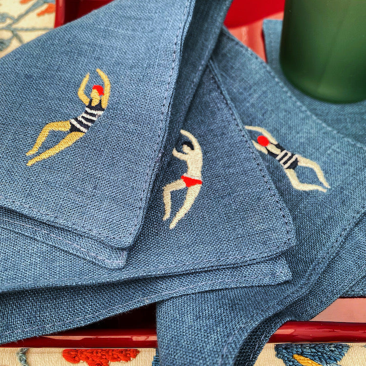 The Voyage Dubai - The Poolside Cocktail Napkins in Denim A chic set of cocktail napkins to elevate your next pool party. A perfect gift for hosts and swimmers alike. Sold in sets of four, with four different motifs in each set.