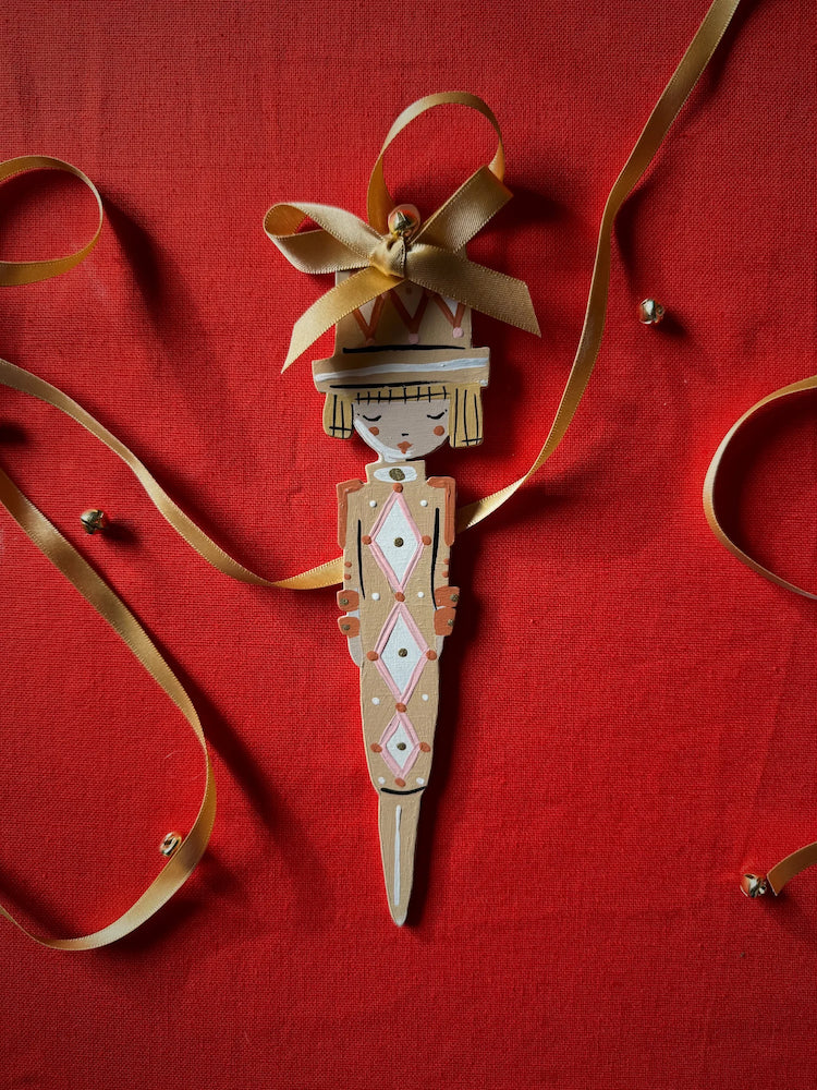 The Voyage Dubai - Cracker Girl in Ochre Hand Painted Wooden Ornament by Alice Mary Lynch