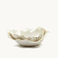 Handmade in a small studio in Notting Hill by Heidi Bishop, this stunning porcelain flower bowl features a double layer of "petals" and is finished with gold edging.
