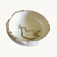 Handmade in a small studio in Notting Hill by Heidi Bishop, this stunning porcelain 'jagged' bowl features a delicate hand painted dove and is finished with gold edging.