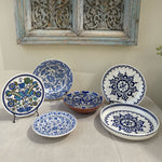 The Voyage Dubai - A set of beautiful hand-painted Iznik ceramic plates from Turkey.  The trio of plates, featuring intricate floral designs in a classic blue and white palette, make a stunning addition to any home.