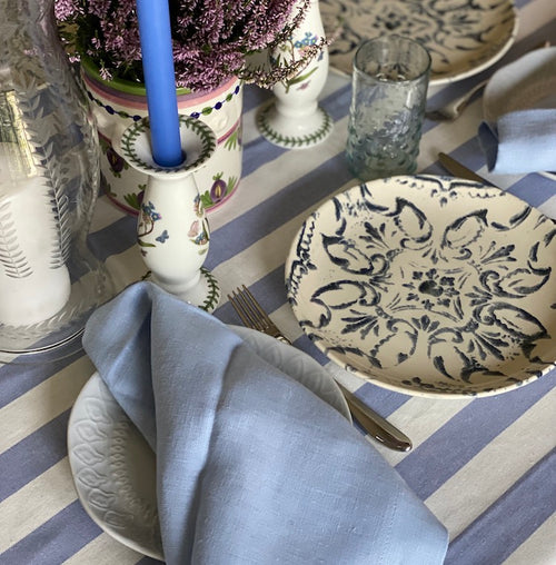 Periwinkle Blue Stripe Tablecloth A classic stripe tablecloth in soft blue and offwhite, finished with a wide hemmed border. Perfect for long lunches and alfresco dining.