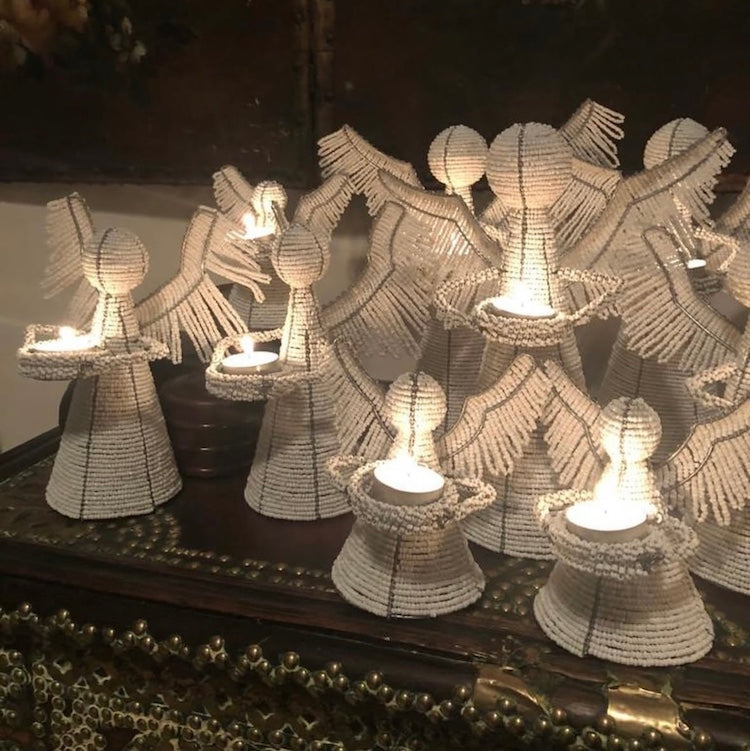 The Voyage Dubai - White Angel Candle Holder.  These charming white angel candle holders add a festive touch to your dining table or mantlepiece. Handmade by Zimbabwean artists 'Bro’s at the Ro', they are stunning on their own or even more lovely when grouped together.