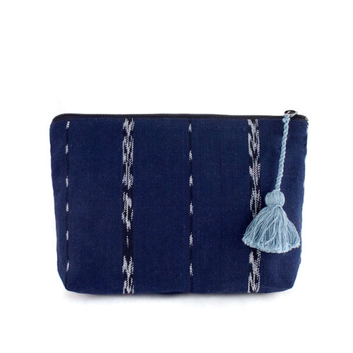 The Voyage Dubai - Nella Zipper Pouch - Indigo  Keep cosmetics and other necessities organised and ready to grab and go with the versatile Nella pouch. Made from handwoven indigo and jaspe (ikat) fabric, woven on a traditional foot loom and finished with a recycled denim lining and blue tassel. 