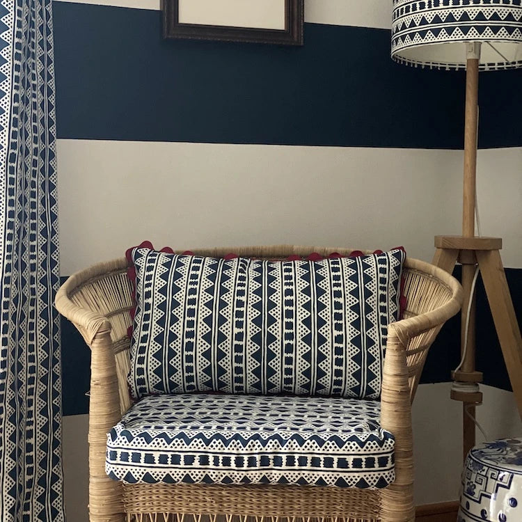 A striking accent cushion crafted from Volga Linen's Kitezh print in Prussian Blue finished with a red trim and concealed zip.