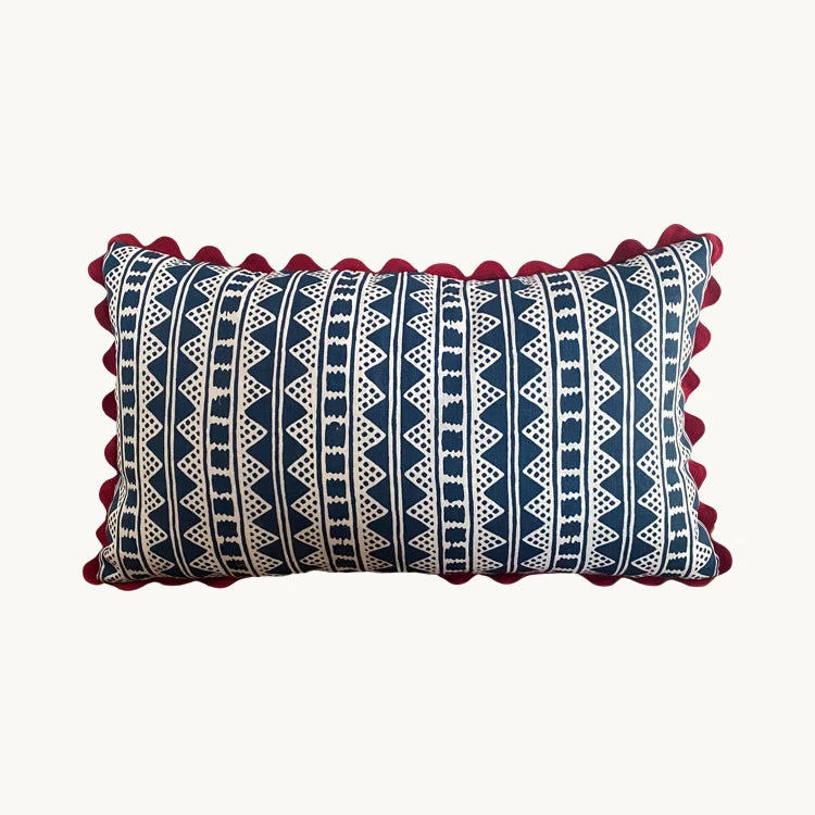 A striking accent cushion crafted from Volga Linen's Kitezh print in Prussian Blue finished with a red trim and concealed zip.