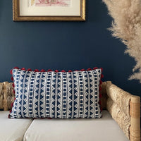A striking accent cushion crafted from Volga Linen's Kitezh print in Prussian Blue finished with a red trim and concealed zip.