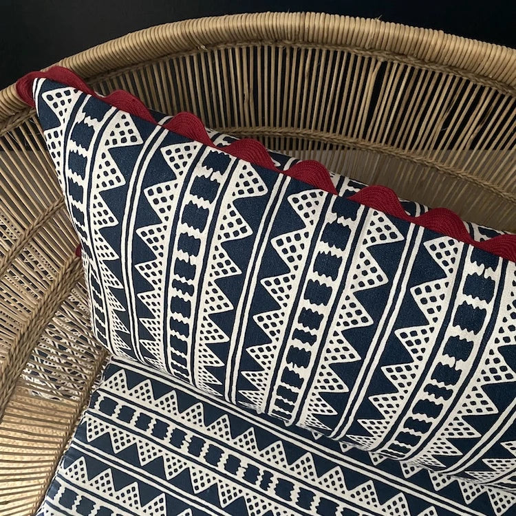 A striking accent cushion crafted from Volga Linen's Kitezh print in Prussian Blue finished with a red trim and concealed zip.