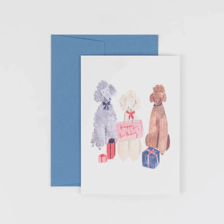 Playful greeting card featuring three cheerful poodles, each wearing a party hat by Peggy & Kate