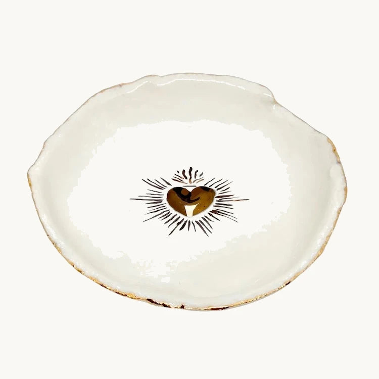 Handmade and hand painted in a small studio in Notting Hill by Heidi Bishop, this stunning porcelain bowl features an incised red 'Sacred Heart' with delicate hand painted gold edging.