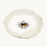 Handmade and hand painted in a small studio in Notting Hill by Heidi Bishop, this stunning porcelain bowl features an incised red 'Sacred Heart' with delicate hand painted gold edging.
