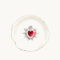 Handmade and hand painted in a small studio in Notting Hill by Heidi Bishop, this stunning porcelain bowl features an incised red 'Sacred Heart' with delicate hand painted gold edging.