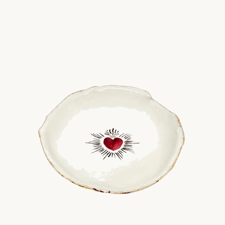 Handmade and hand painted in a small studio in Notting Hill by Heidi Bishop, this stunning porcelain bowl features an incised red 'Sacred Heart' with delicate hand painted gold edging.