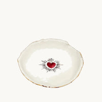 Handmade and hand painted in a small studio in Notting Hill by Heidi Bishop, this stunning porcelain bowl features an incised red 'Sacred Heart' with delicate hand painted gold edging.