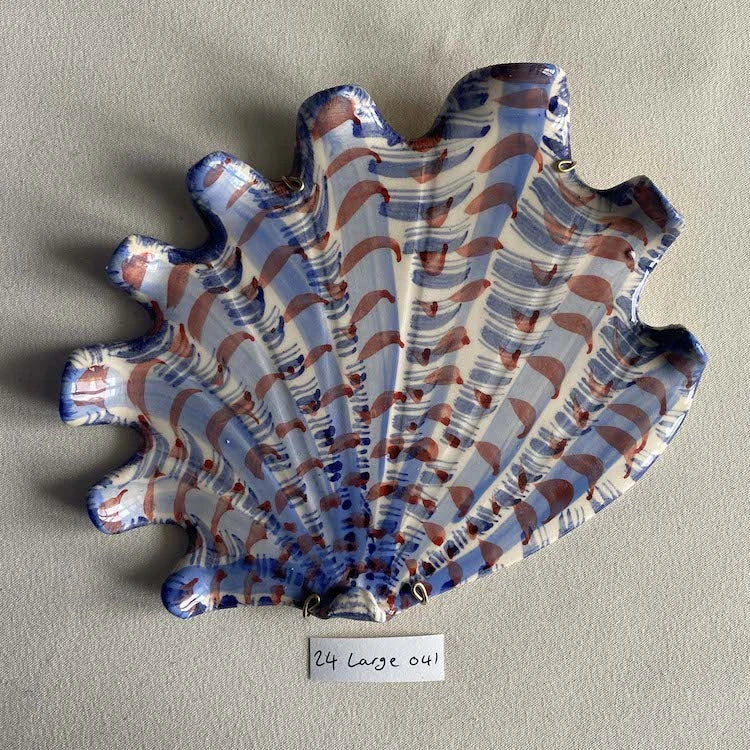 Hand-made and decorated ceramic shells from South African artist Lucie de Moyencourt.