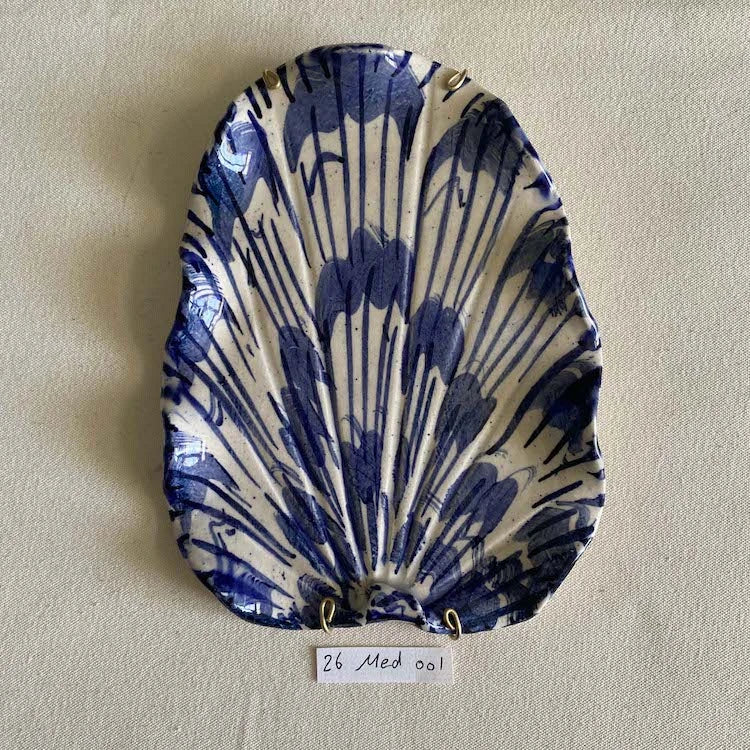 Hand-made and decorated ceramic shells from South African artist Lucie de Moyencourt.