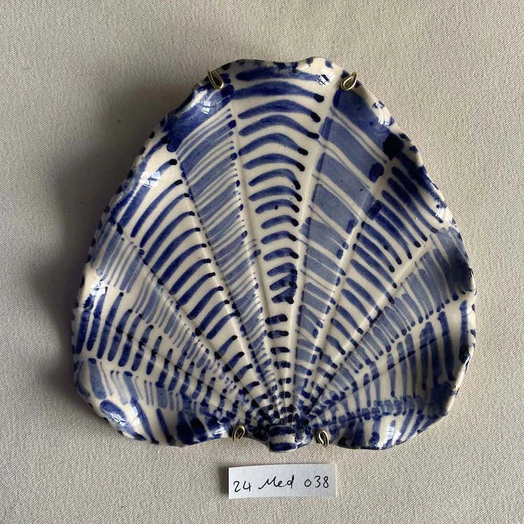 Hand-made and decorated ceramic shells from South African artist Lucie de Moyencourt.