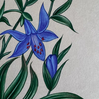 Close-up of a blue lily with red-spotted centre and a bud among long green leaves, painted on handmade paper