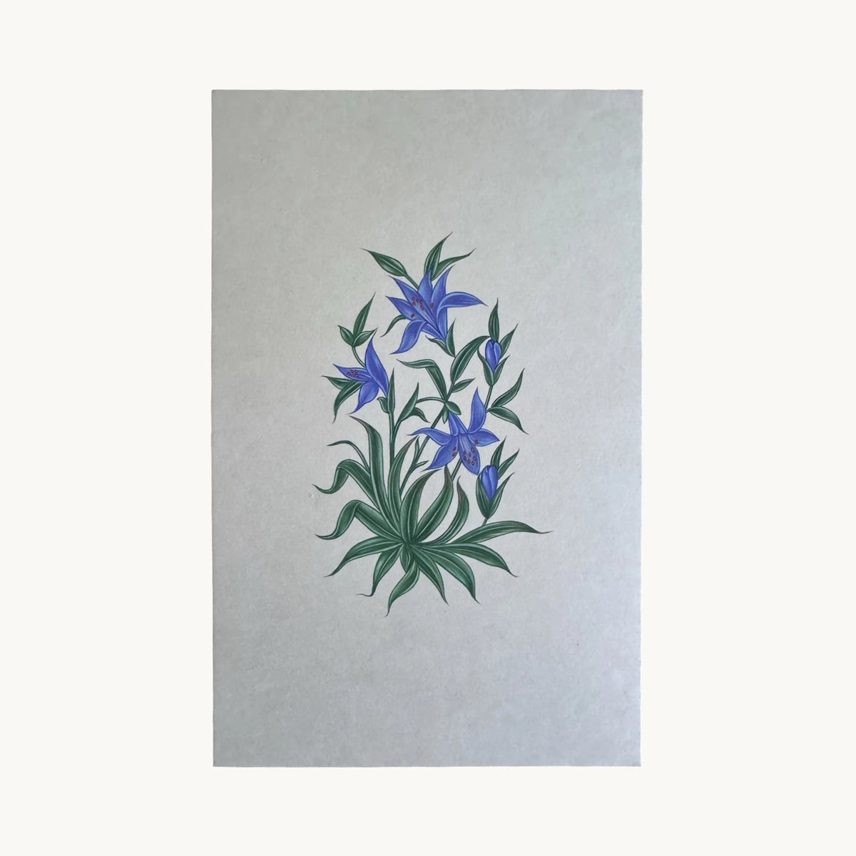 Original miniature painting of blue lilies in flower and bud above a clump of green leaves, on handmade paper