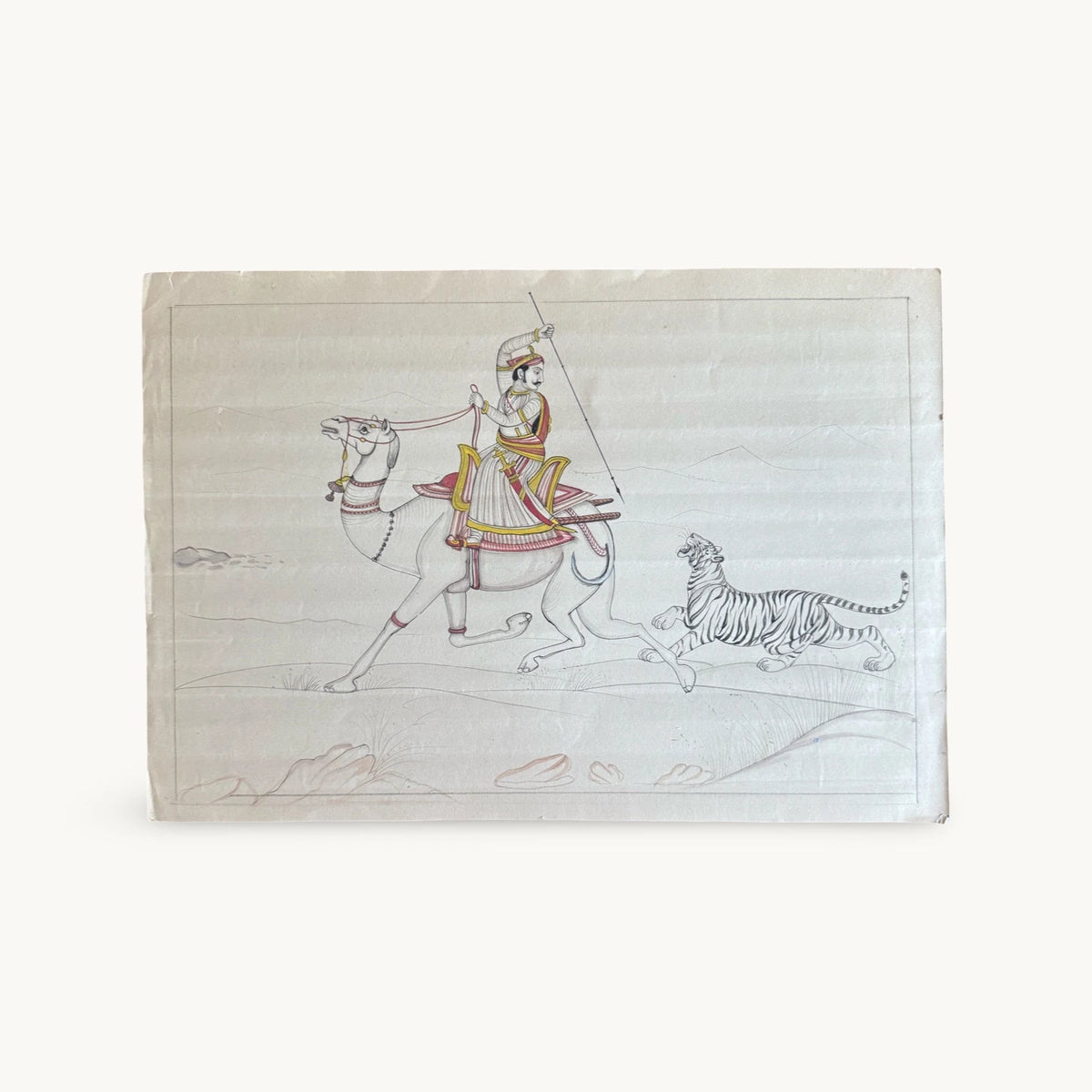 Original miniature painting of a Maharaja in a turban raising a spear on a galloping camel, with a tiger running beside it, on old paper