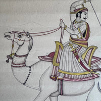 Detail of a Maharaja riding a galloping camel, drawn with gold and maroon on the rider, on old paper