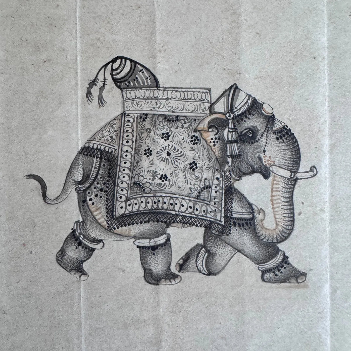 Original miniature painting of a decorated elephant in a patterned blanket and anklets, painted in dots and fine line on old paper