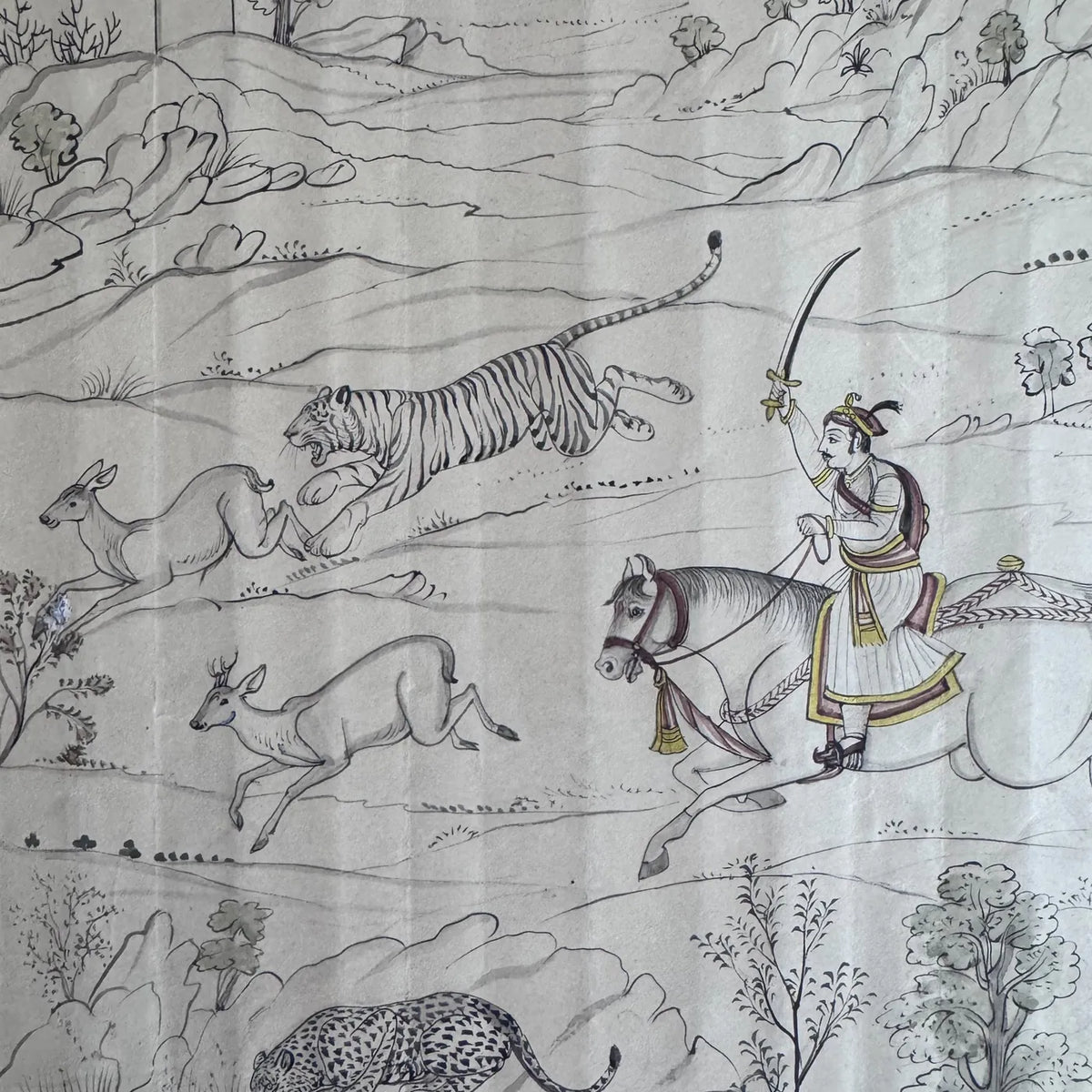 Detail of a Maharaja on horseback raising a sword beside a leaping tiger and two deer, in fine line work on old paper