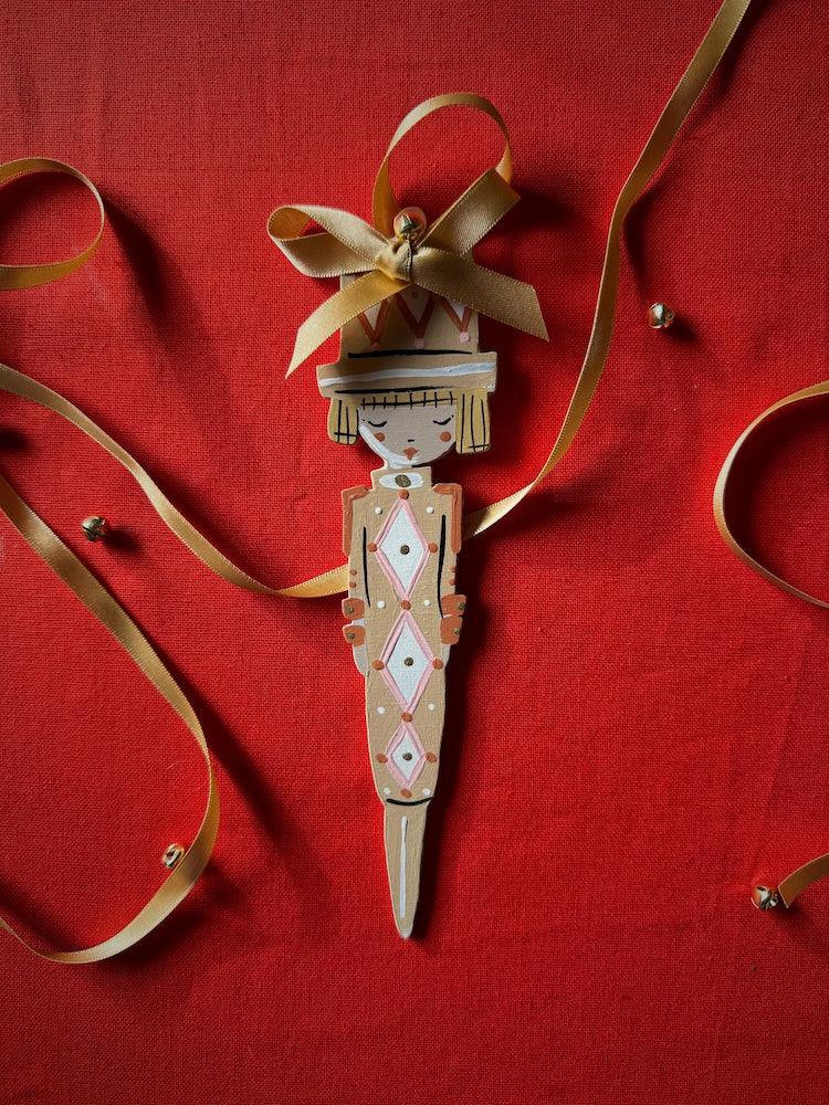Cracker Girl in Ochre Hand Painted Wooden Ornament by Alice Mary Lynch - The Voyage Dubai