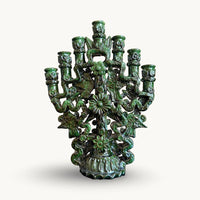 Green glazed candelabra with seven candle cups, birds, flowers and ribbon-like arms on a scalloped base
