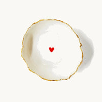 Handmade in a small studio in Notting Hill by Heidi Bishop, this stunning porcelain 'jagged' bowl features a delicate hand painted heart and is finished with gold edging.