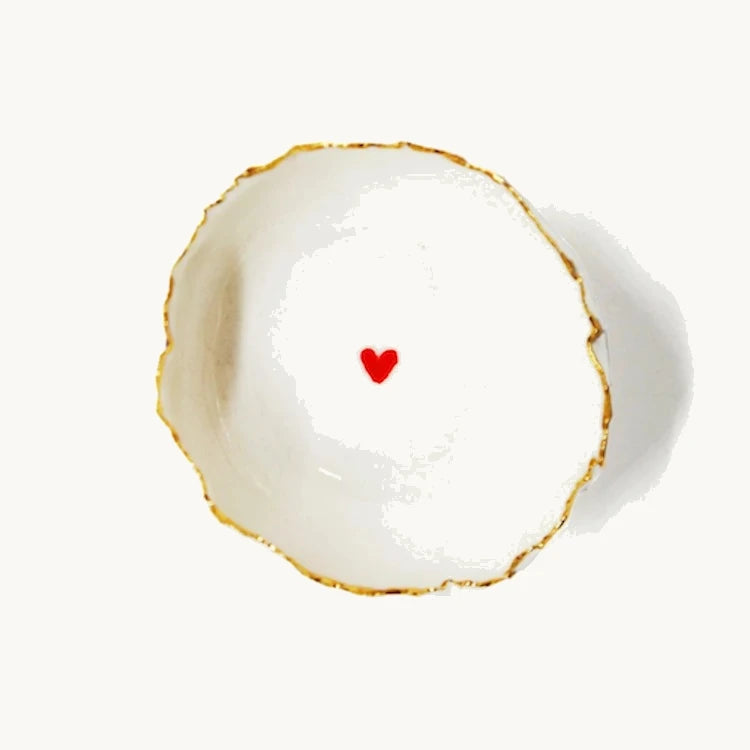 Handmade in a small studio in Notting Hill by Heidi Bishop, this stunning porcelain 'jagged' bowl features a delicate hand painted heart and is finished with gold edging.
