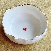 Handmade in a small studio in Notting Hill by Heidi Bishop, this stunning porcelain 'jagged' bowl features a delicate hand painted heart and is finished with gold edging.