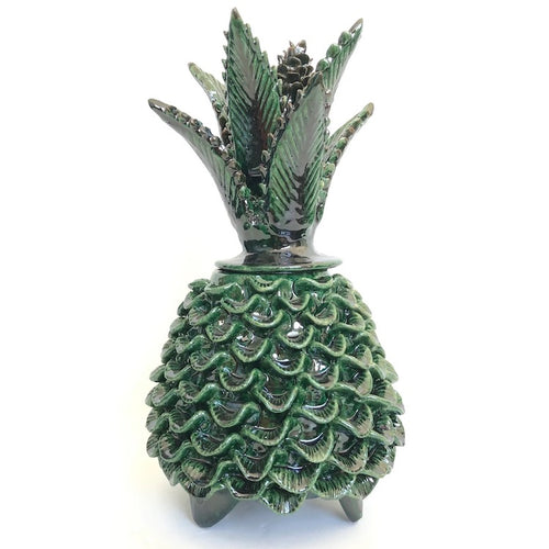 The Voyage Dubai - Piña Michoacána (Glazed Pineapple Urn)  Handcrafted using the 'pastillaje' technique, the striking green glazed terracotta pineapple urn features a striking leaf and cone lid and intricate detailing on the base. Each piece is modeled by hand by talented artists from San Jose de Gracia, Tangancicuaro.