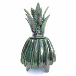 The Voyage Dubai - Piña Michoacána (Glazed Pineapple Urn)  Handcrafted using the 'pastillaje' technique, the striking green glazed terracotta pineapple urn features a striking leaf and cone lid and intricate detailing on the base. Each piece is modeled by hand by talented artists from San Jose de Gracia, Tangancicuaro.