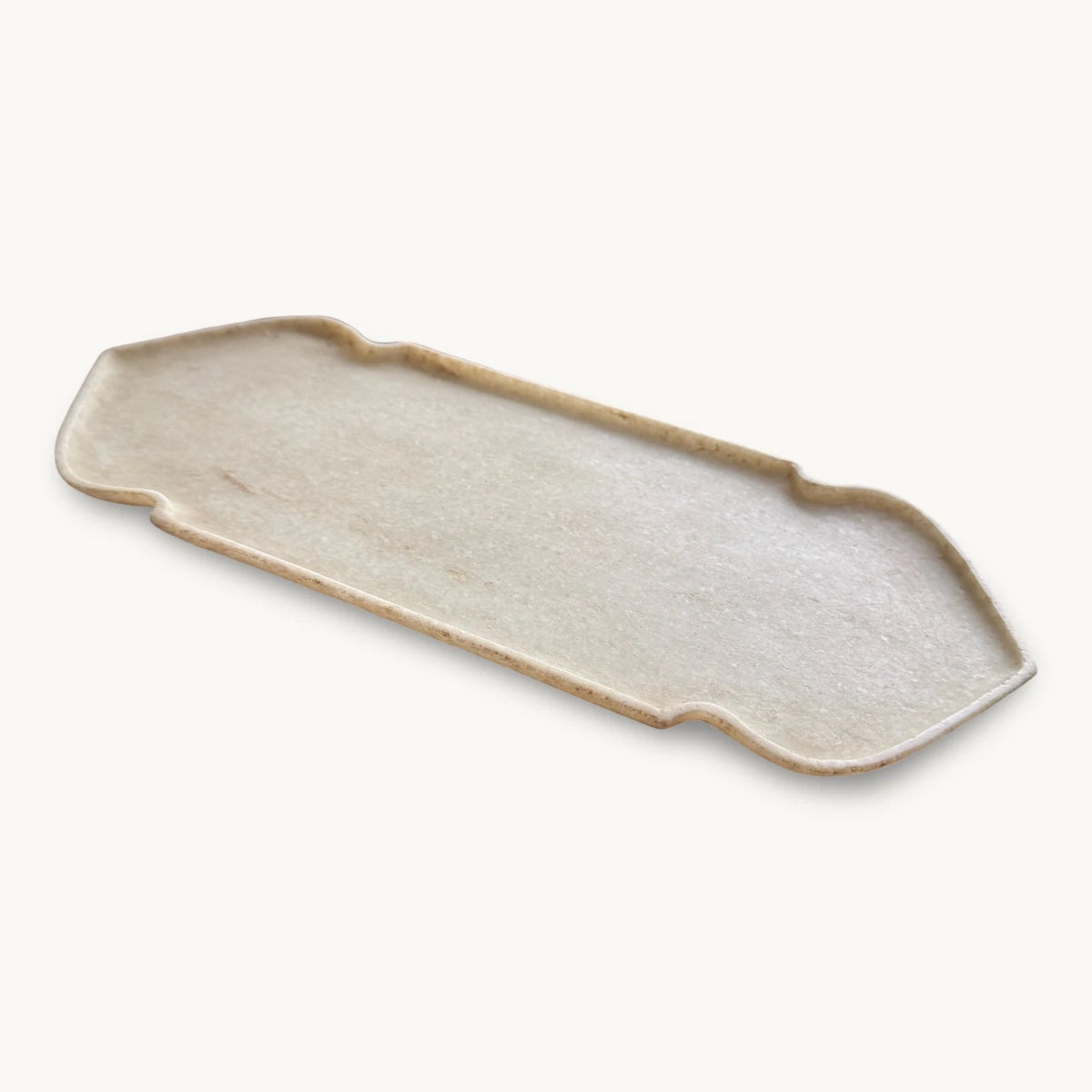 Narrow white Makrana marble tray with notched corners and a shallow raised edge, shown at an angle