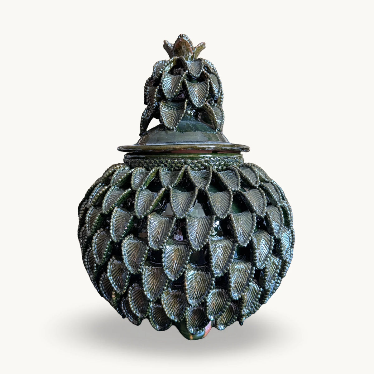 Wide green Piña Michoacána urn with a leaf crown on the lid and overlapping beaded leaves across the body