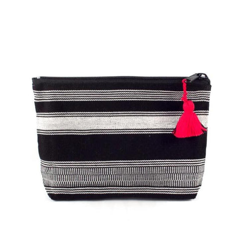 The Voyage Dubai - Nella Zipper Pouch - Black Keep cosmetics and other necessities organised and ready to grab and go with the versatile Nella pouch. Made from handwoven black and white fabric, woven on a traditional foot loom, with a recycled denim lining, the Nella pouch is finished with a contrasting red tassel on the zipper pull for a chic, sophisticated look.