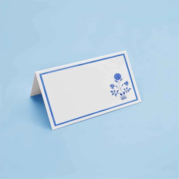 The Voyage Dubai - Blue Flower Place Cards by Aquarela  Originally illustrated in watercolour by Portuguese artist India who draws inspiration from her home in Comporta and summers spent in the Bahamas.   Printed on luxury 200gsm textured paper.  Size: 10cm x 8cm   Sold in packs of twelve.