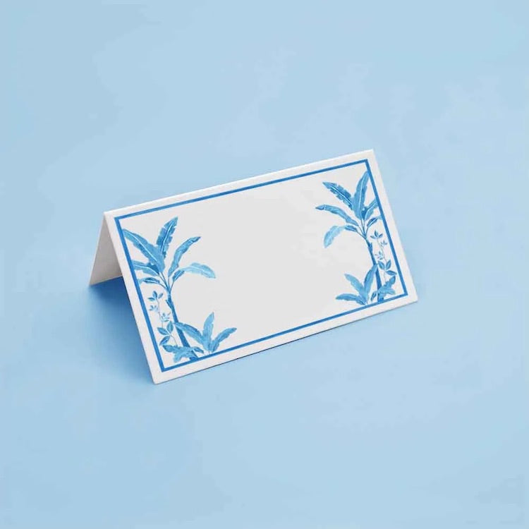 The Voyage Dubai - Blue Palms Place Cards by Aquarela  Originally illustrated in watercolour by Portuguese artist India who draws inspiration from her home in Comporta and summers spent in the Bahamas.  Printed on luxury 200gsm textured paper.  Size: 10cm x 8cm   Sold in packs of twelve.