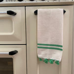 The Voyage Dubai - Made in Tangier Jibli Hand Towel - Green  Hand woven in Morocco from 100% pure cotton, the Jibli Hand Towel in double stripe is a great way to add a pop of colour to a guest bathroom, drinks cart or kitchen. The towels are finished with a fringe of pom poms and are made from a wonderfully soft yet highly durable handwoven cotton, making them perfect for everyday use.   Use as table napkins, tea towels or hand towels.