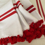 The Voyage Dubai - Made in Tangier Set of 6 Jibli Napkins - Red Stripe Inspired by the Jibli (country) women of Northern Morocco these generously sized table napkins add an element of fun to any table. Available in pure white cotton, as well as fun colourful stripes on a creamy white base, each napkin is finished with matching pom poms. Use as table napkins, tea towels or hand towels.