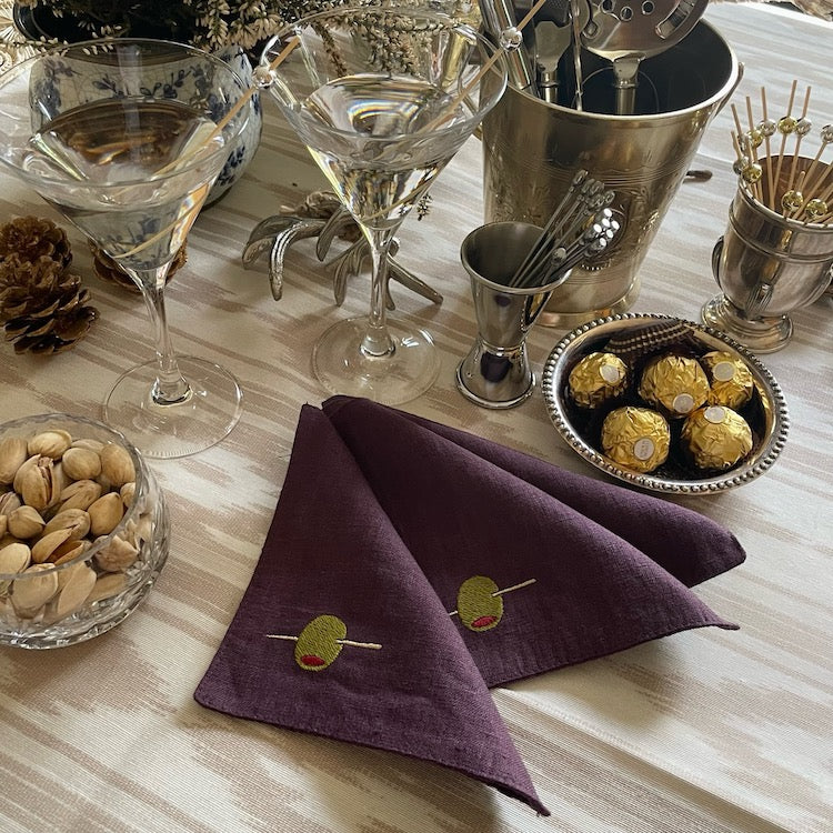 The Voyage Dubai - Shaken not Stirred Cocktail Napkins in Plum  A must-have for all martini lovers, these fun cocktail napkins come in a gorgeous plum colour are sure to elevate your aperitivo hour.  Our cocktail napkins are handcrafted from 100% European linen that has been stonewashed and softened giving them a wonderful, luxurious feel. The cocktail napkins come beautifully presented making for the perfect gift.