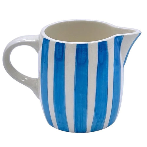 The Voyage Dubai - Milk Jug in Light Blue Stripes  Handmade and hand painted in Malta in contemporary thick stripes, designed to complement the rest of the Villa Bologna collection. The chunky bands of colour are as brilliant on their own as they are when paired with the scroll pattern and/or the Palm pieces.  Use as a milk jug or to serve sauces, dressings and gravy and create an informal setting that’s pure perfection. A useful addition to any table or kitchen, and perfect for gifting.